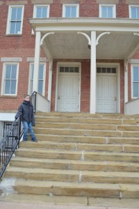 Ezra standing on the steps of the original court house